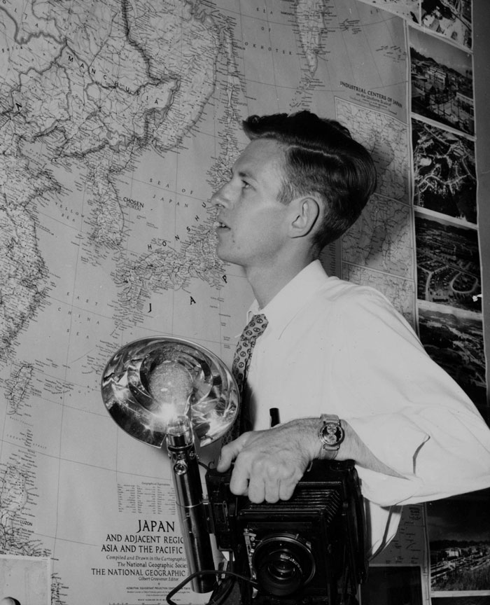 Young Ed Westcott Looking at Map